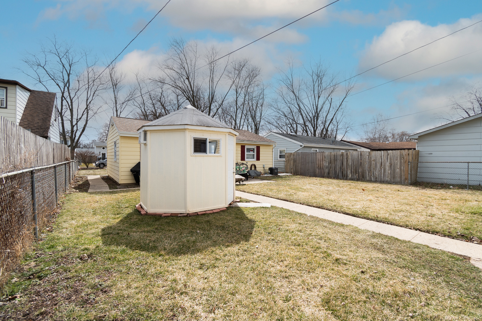 2106 20th Street Zion, IL 60099 - Photo 19 of 22 a view of a white house with a yard covered in snow