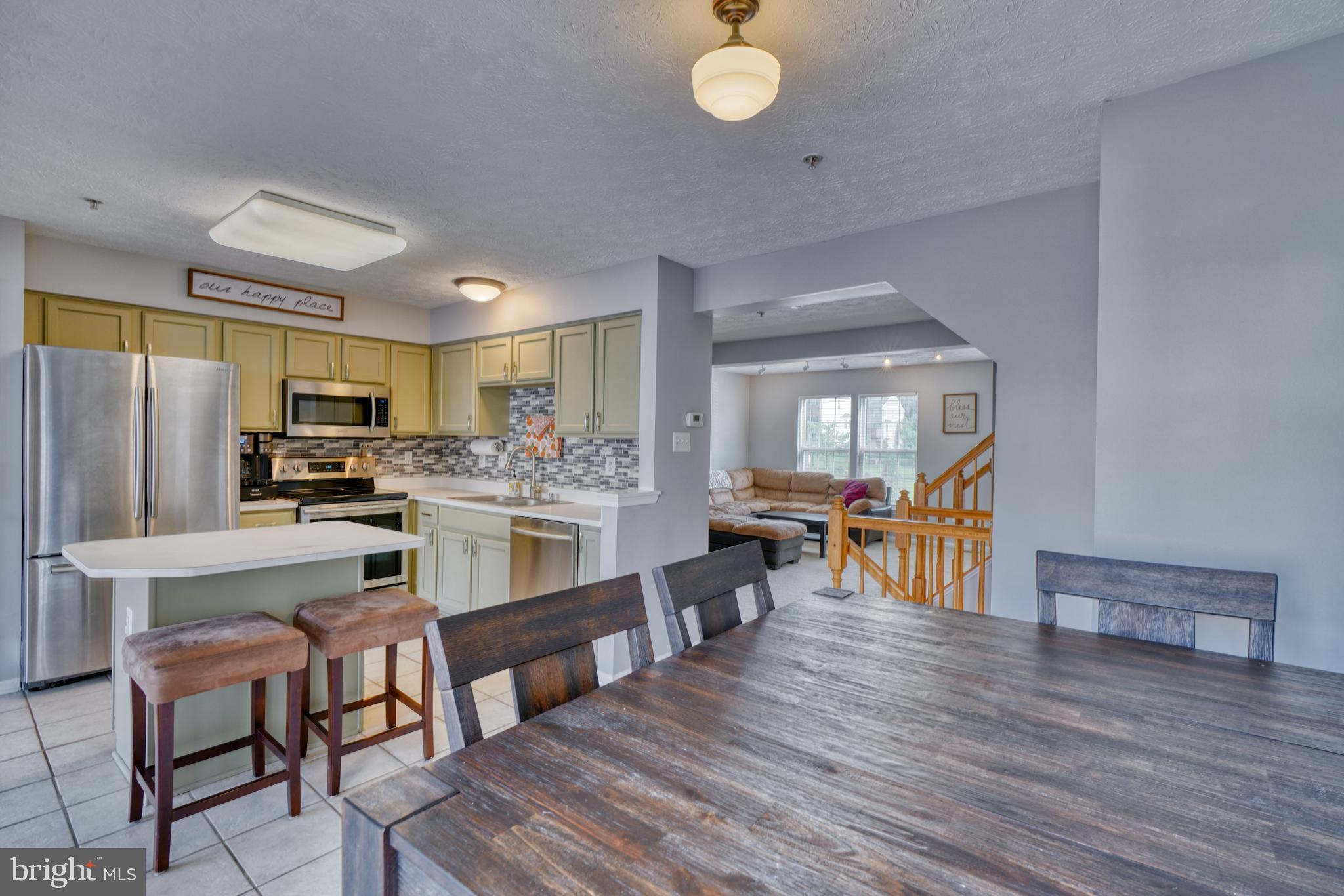 5030 Finsbury Road Rosedale, MD 21237 - Photo 12 of 49 a kitchen with stainless steel appliances granite countertop a stove refrigerator and chairs