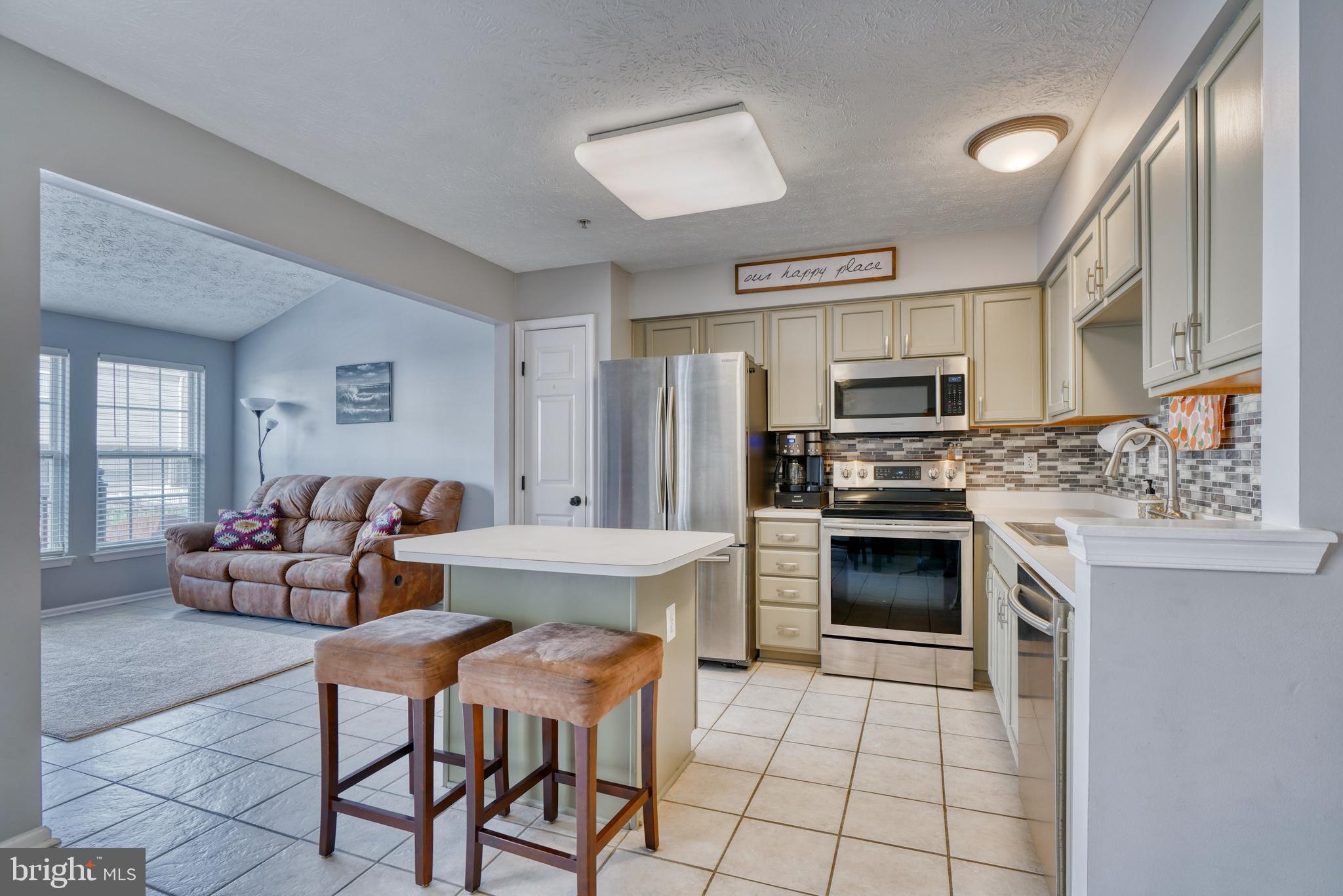 5030 Finsbury Road Rosedale, MD 21237 - Photo 14 of 49 a kitchen with a stove a sink and a refrigerator