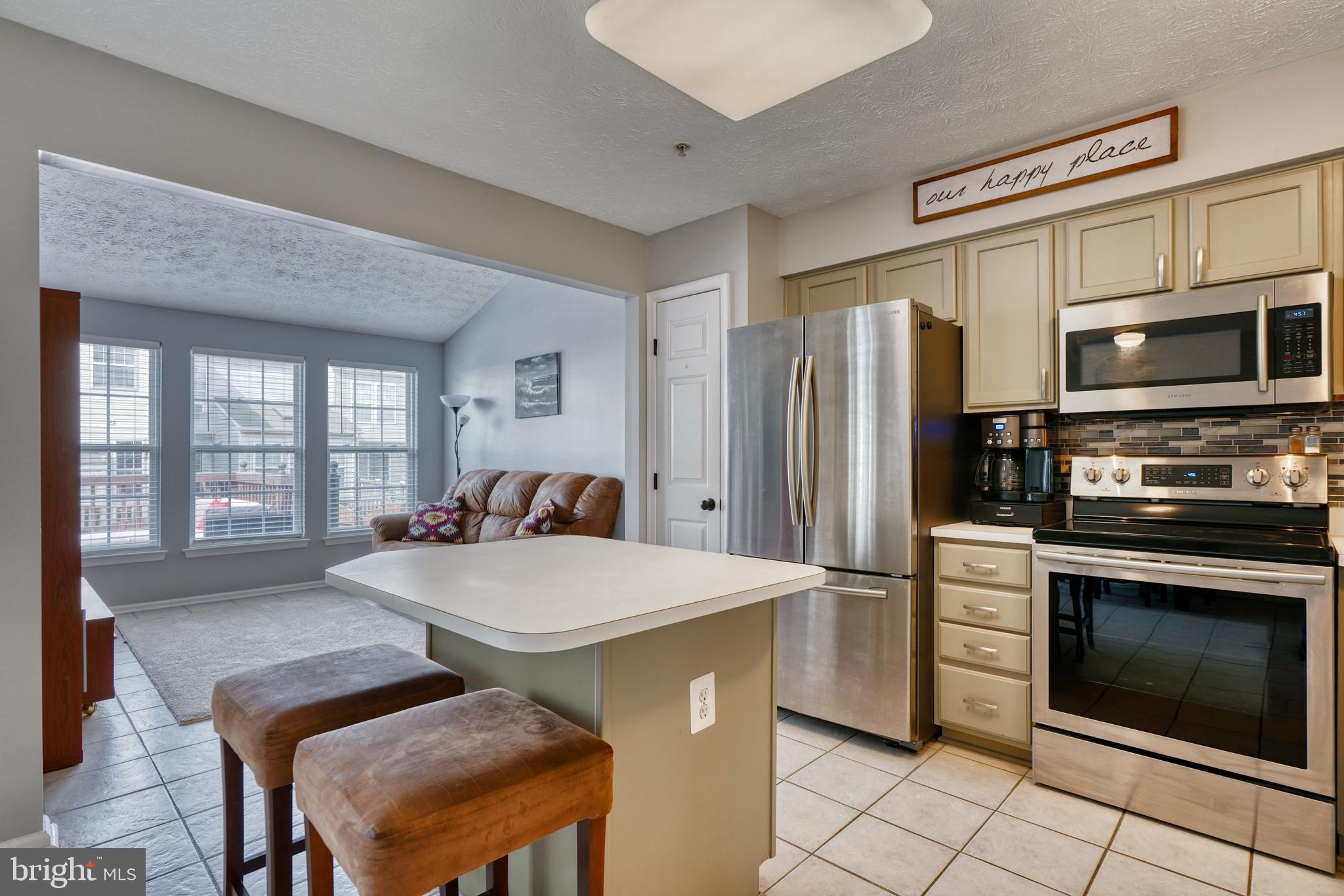 5030 Finsbury Road Rosedale, MD 21237 - Photo 15 of 49 a kitchen with stainless steel appliances a stove a sink island and a refrigerator