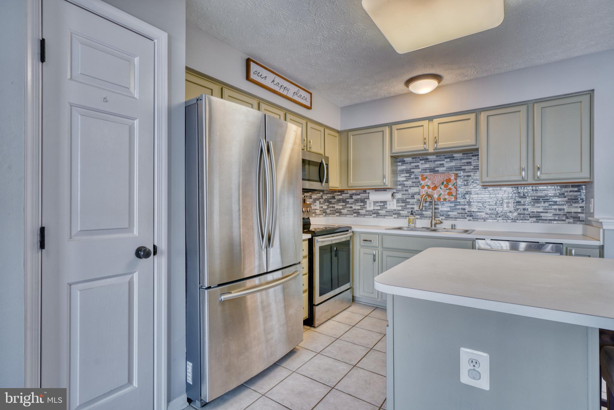 5030 Finsbury Road Rosedale, MD 21237 - Photo 18 of 49 a kitchen with stainless steel appliances a refrigerator sink and microwave