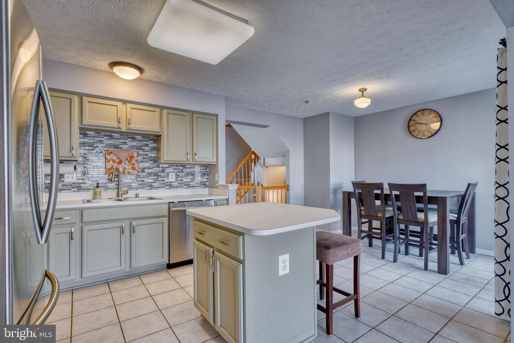5030 Finsbury Road Rosedale, MD 21237 - Photo 19 of 49 a kitchen with a sink and chairs