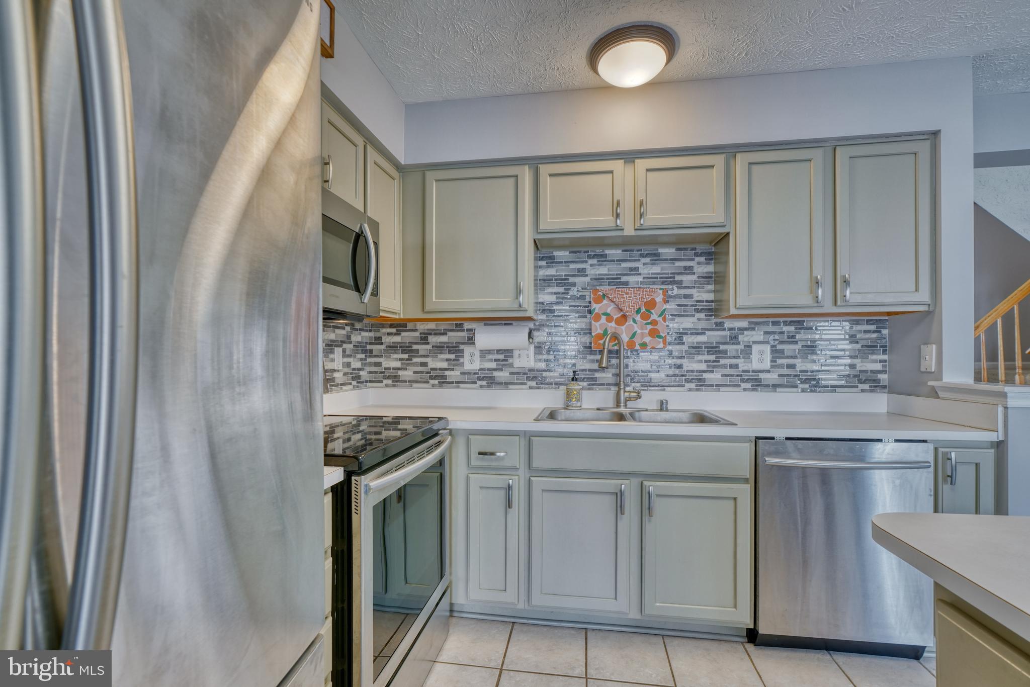 5030 Finsbury Road Rosedale, MD 21237 - Photo 20 of 49 a kitchen with stainless steel appliances granite countertop a sink stove and cabinets