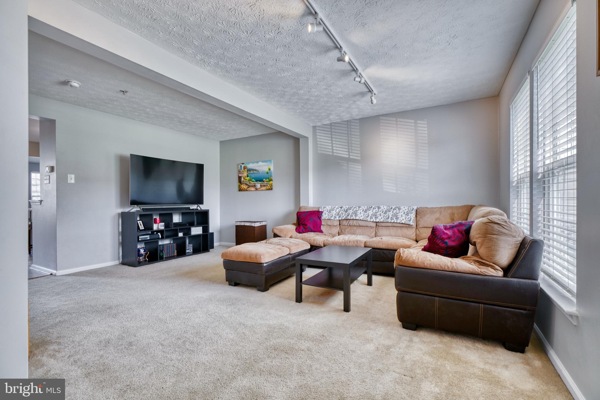 5030 Finsbury Road Rosedale, MD 21237 - Photo 2 of 49 a living room with furniture and a flat screen tv