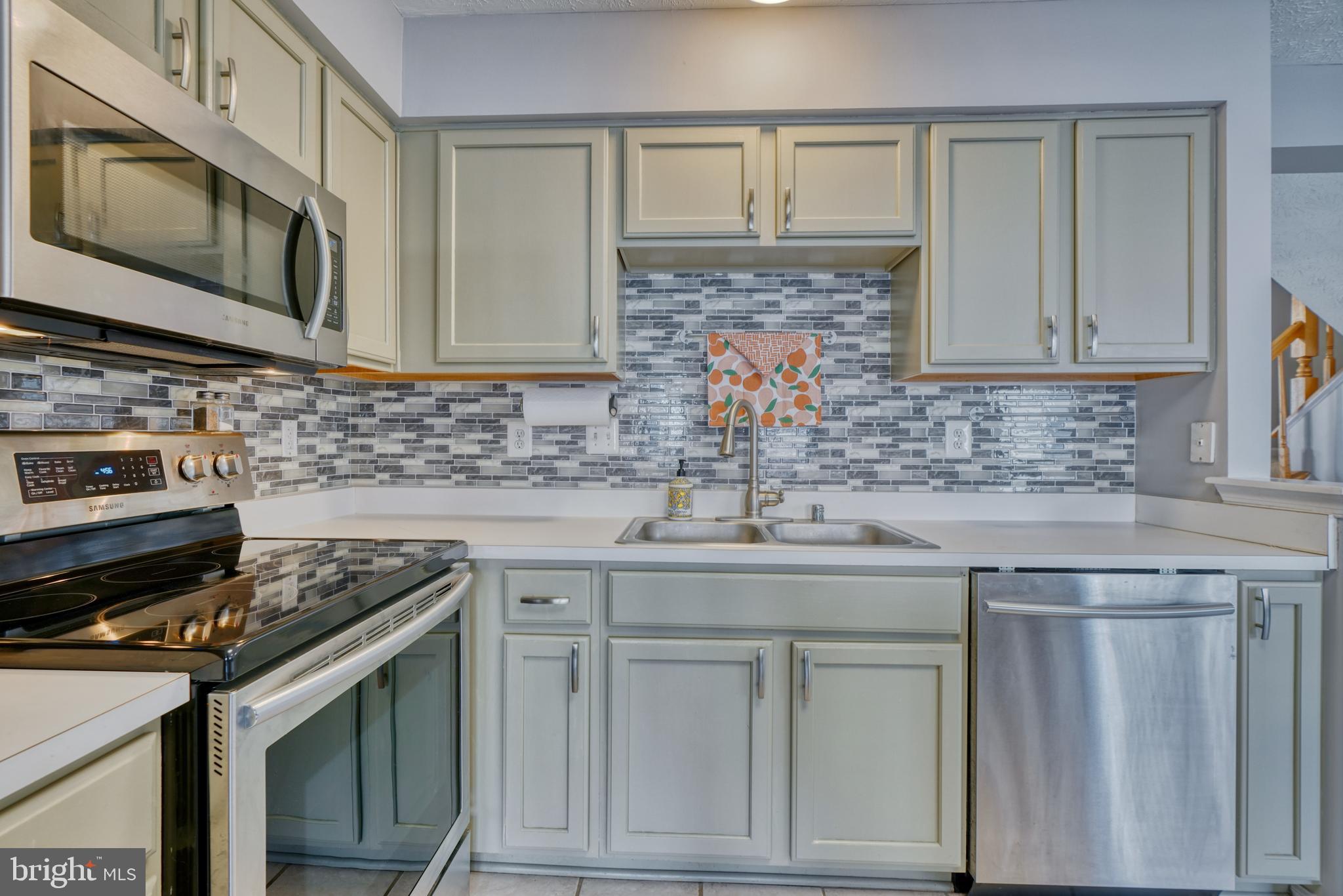 5030 Finsbury Road Rosedale, MD 21237 - Photo 21 of 49 a kitchen with stainless steel appliances granite countertop a sink stove and microwave