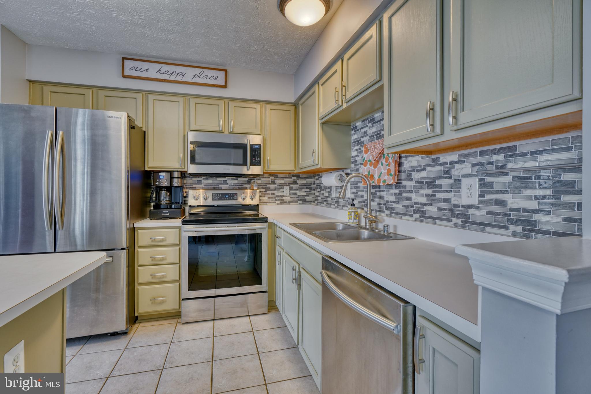 5030 Finsbury Road Rosedale, MD 21237 - Photo 22 of 49 a kitchen with a sink stove and refrigerator