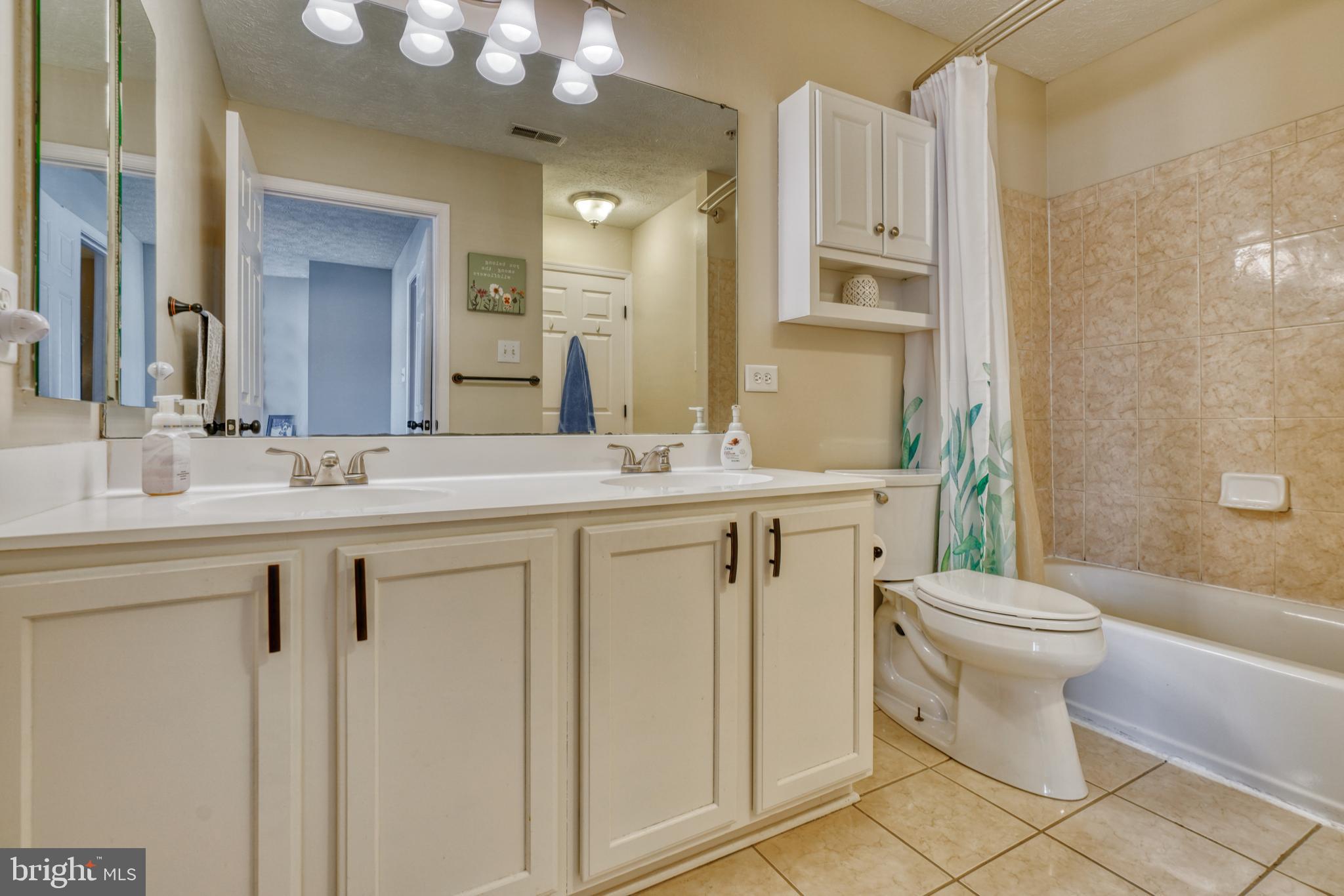 5030 Finsbury Road Rosedale, MD 21237 - Photo 34 of 49 a bathroom with a sink vanity mirror and toilet