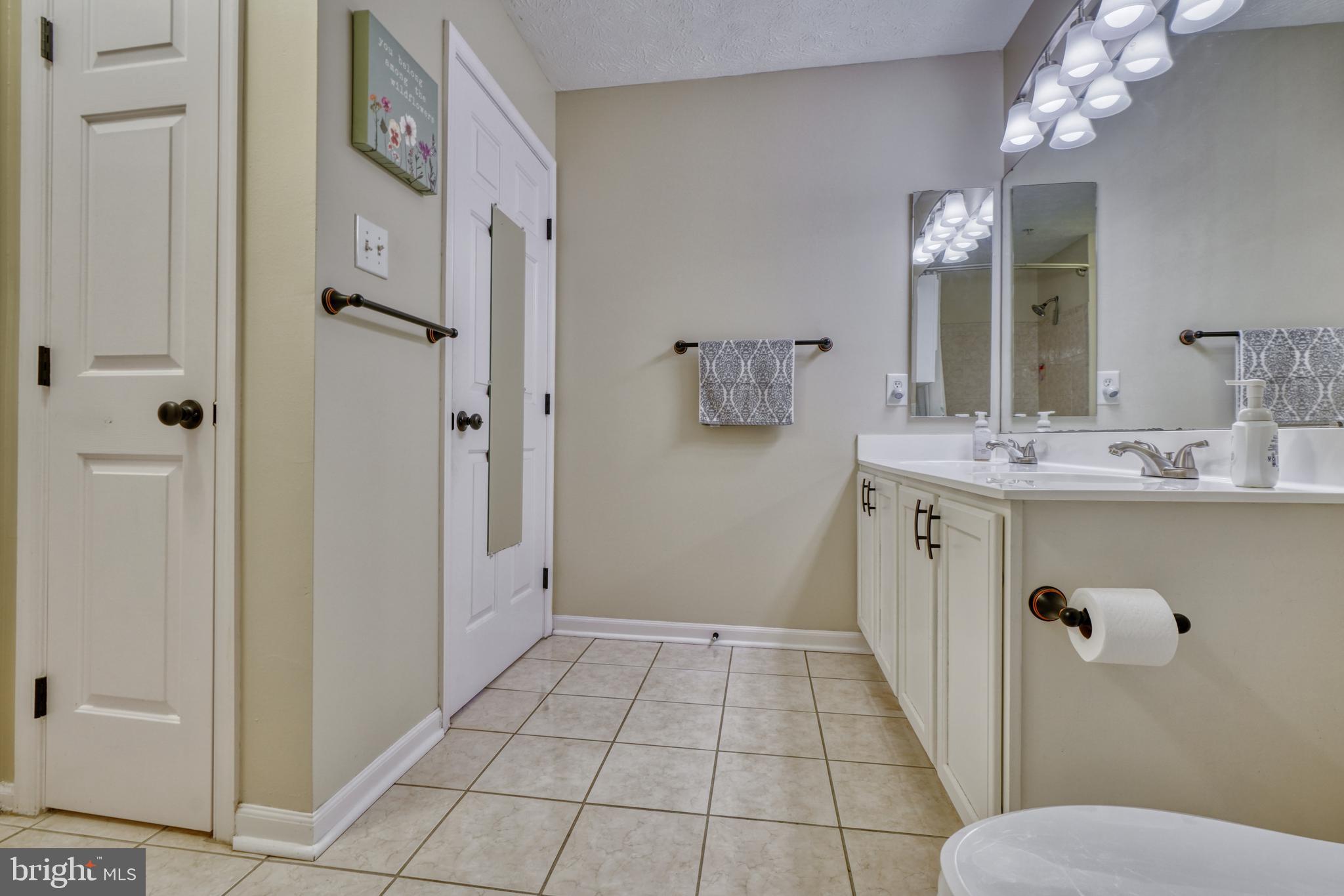 5030 Finsbury Road Rosedale, MD 21237 - Photo 36 of 49 a bathroom with a sink a toilet and shower