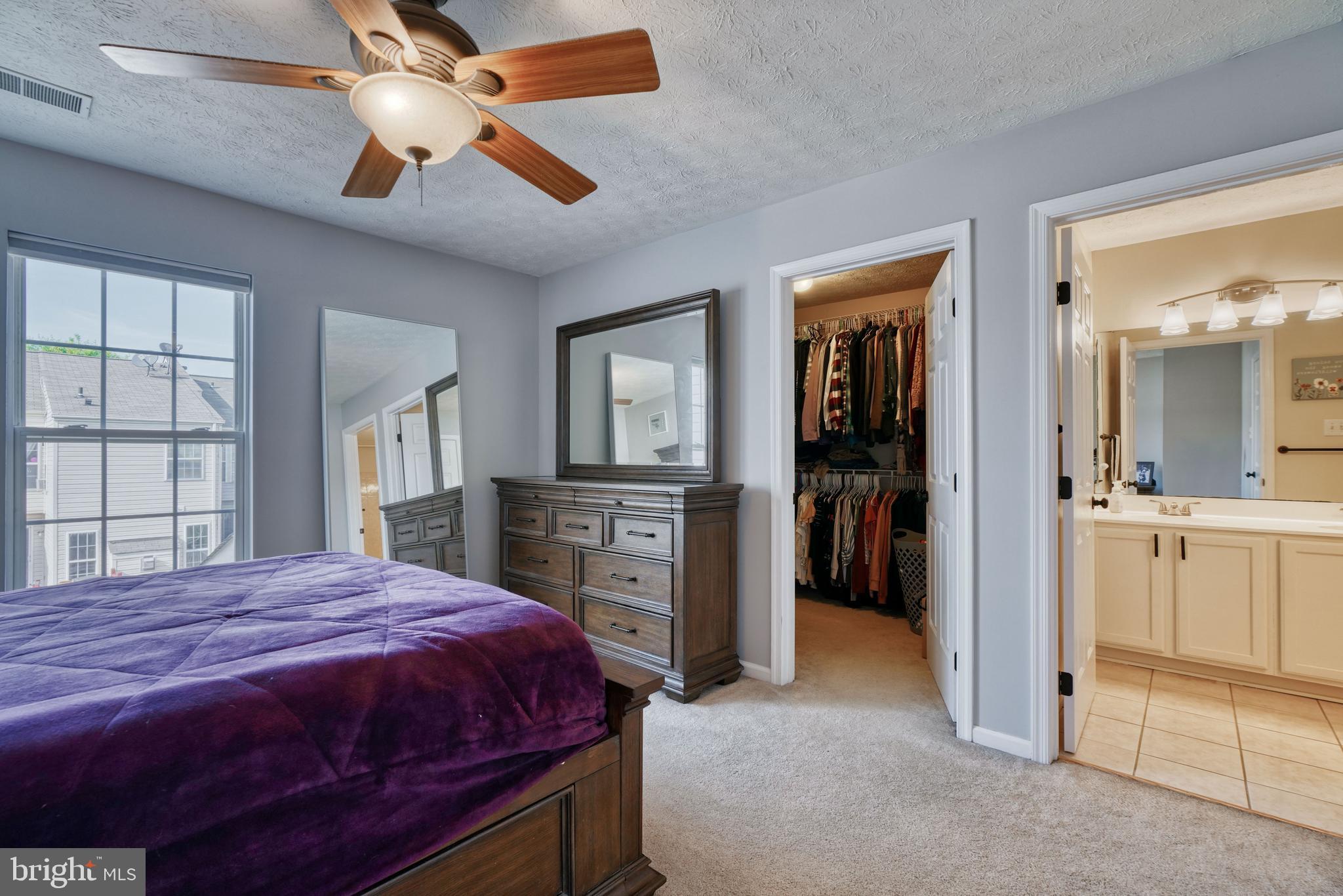 5030 Finsbury Road Rosedale, MD 21237 - Photo 38 of 49 a spacious bedroom with a bed and a chandelier