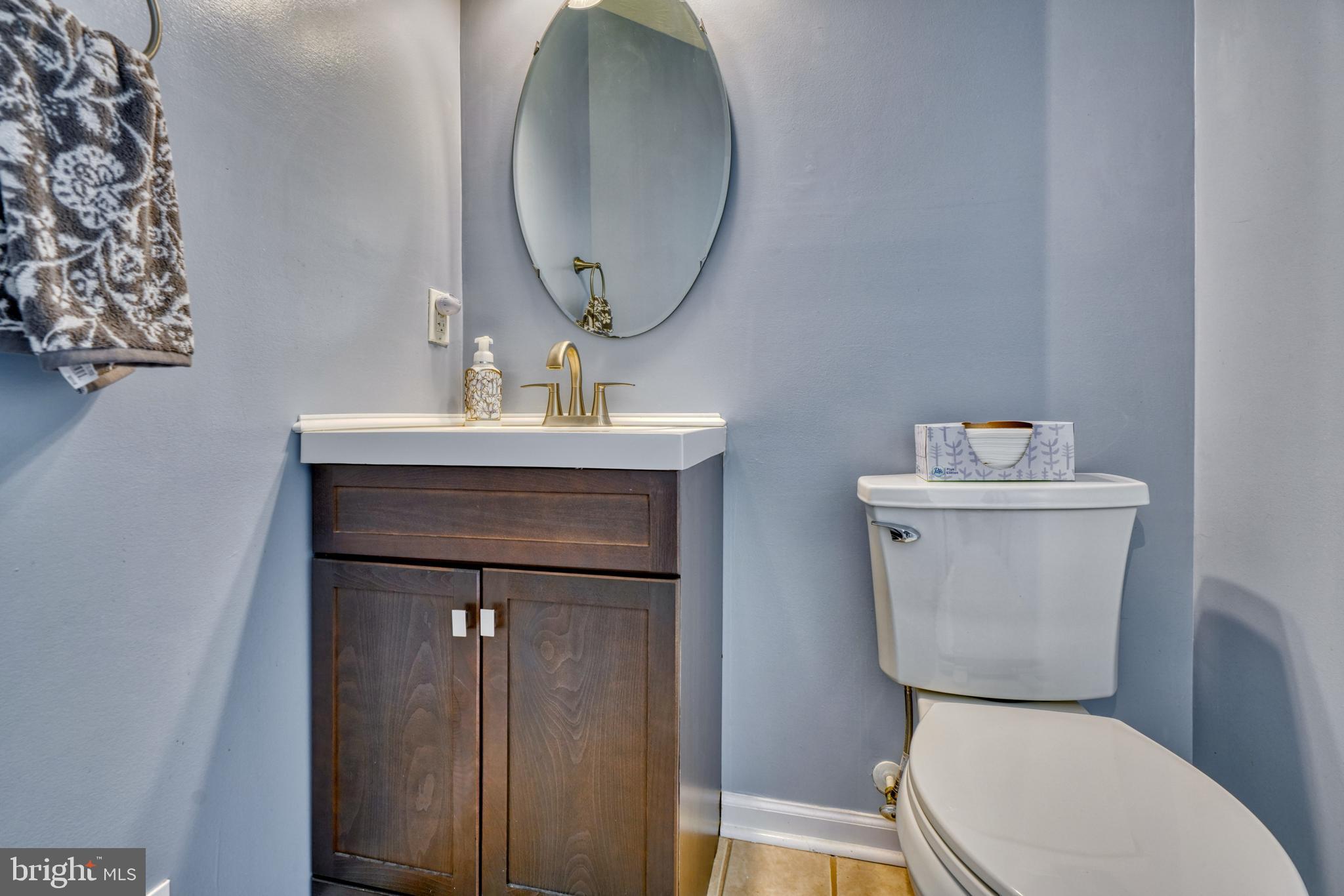 5030 Finsbury Road Rosedale, MD 21237 - Photo 8 of 49 a bathroom with a toilet a sink and a mirror