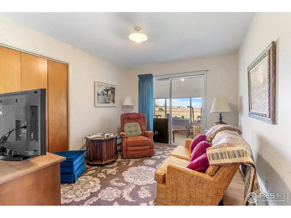 a dining room with a table chairs and a kitchen view