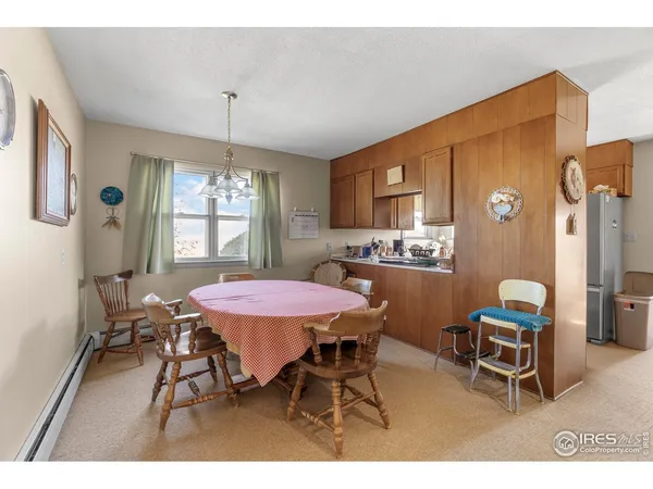 a bedroom with a bed window and a dresser in it