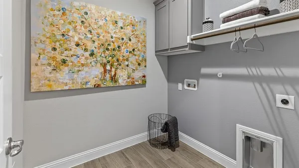 a bedroom with a bed and painting on the wall