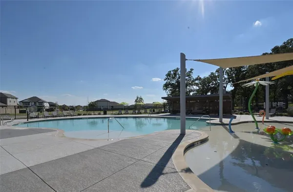 a swimming pool with outdoor seating and garden