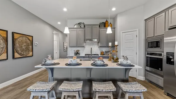 a kitchen with stainless steel appliances a sink stove and cabinets