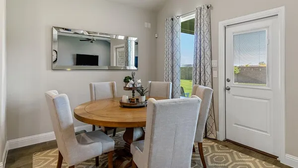 a kitchen with a sink a stove and chairs