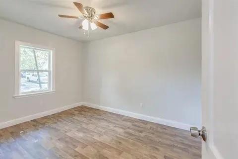 221 Braz Street Bonham, TX 75418 - Photo 12 of 12 Spare room with wood finished floors and a ceiling fan