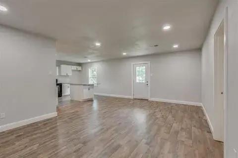 221 Braz Street Bonham, TX 75418 - Photo 2 of 12 Unfurnished living room with light wood-style flooring and recessed lighting