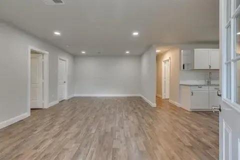 221 Braz Street Bonham, TX 75418 - Photo 6 of 12 Unfurnished living room with light wood-type flooring and recessed lighting