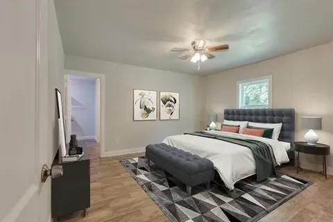 221 Braz Street Bonham, TX 75418 - Photo 8 of 12 Bedroom with light wood finished floors and ceiling fan