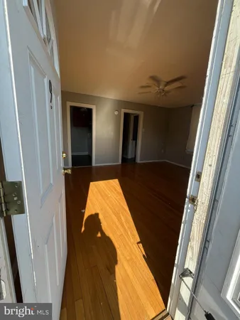 a view of a room with wooden floor