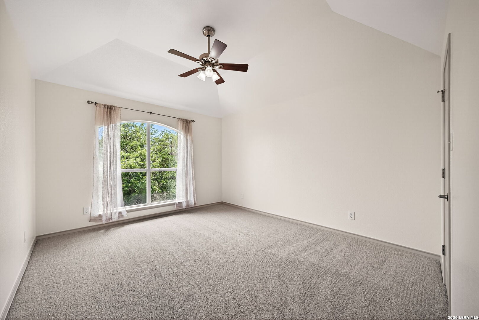 17431 Helotes Spring Road Helotes, TX 78023 - Photo 30 of 50 a view of a room with a window and a fan