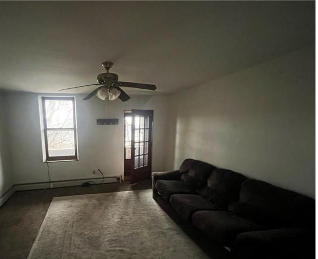 2918 Leander Street Pittsburgh, PA 15219 - Photo 2 of 9 a living room with furniture and a ceiling fan