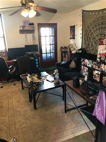 2918 Leander Street Pittsburgh, PA 15219 - Photo 3 of 9 a living room with furniture and a fireplace