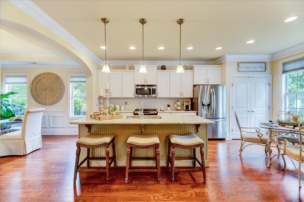 a large kitchen with a table and chairs