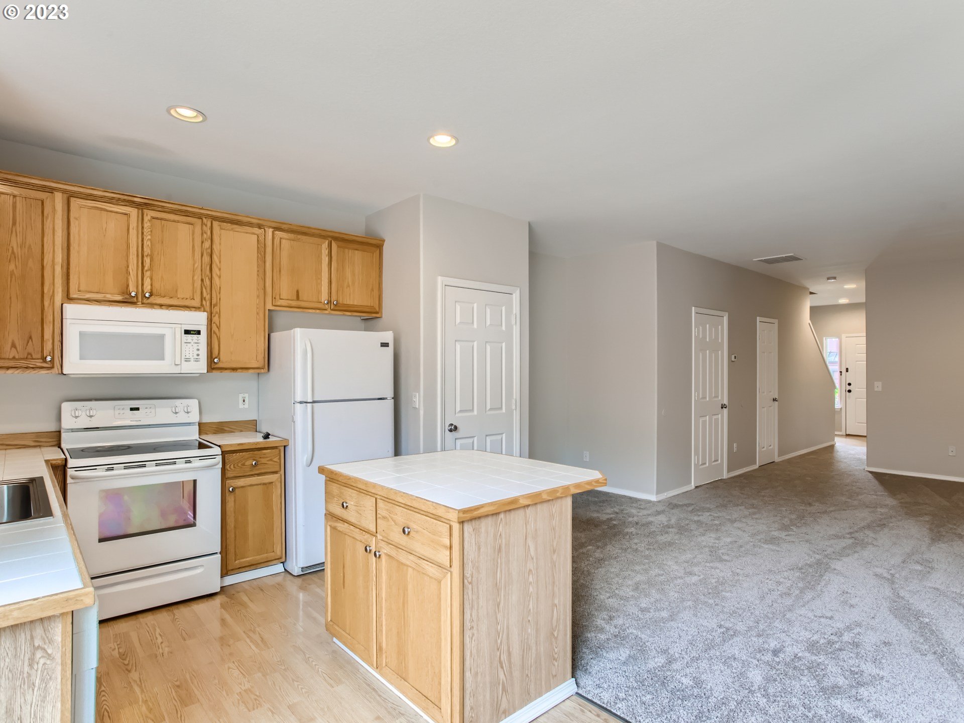 5877 Southeast 15th Drive Gresham, OR 97080 - Photo 11 of 27 a kitchen with refrigerator cabinets and wooden floor