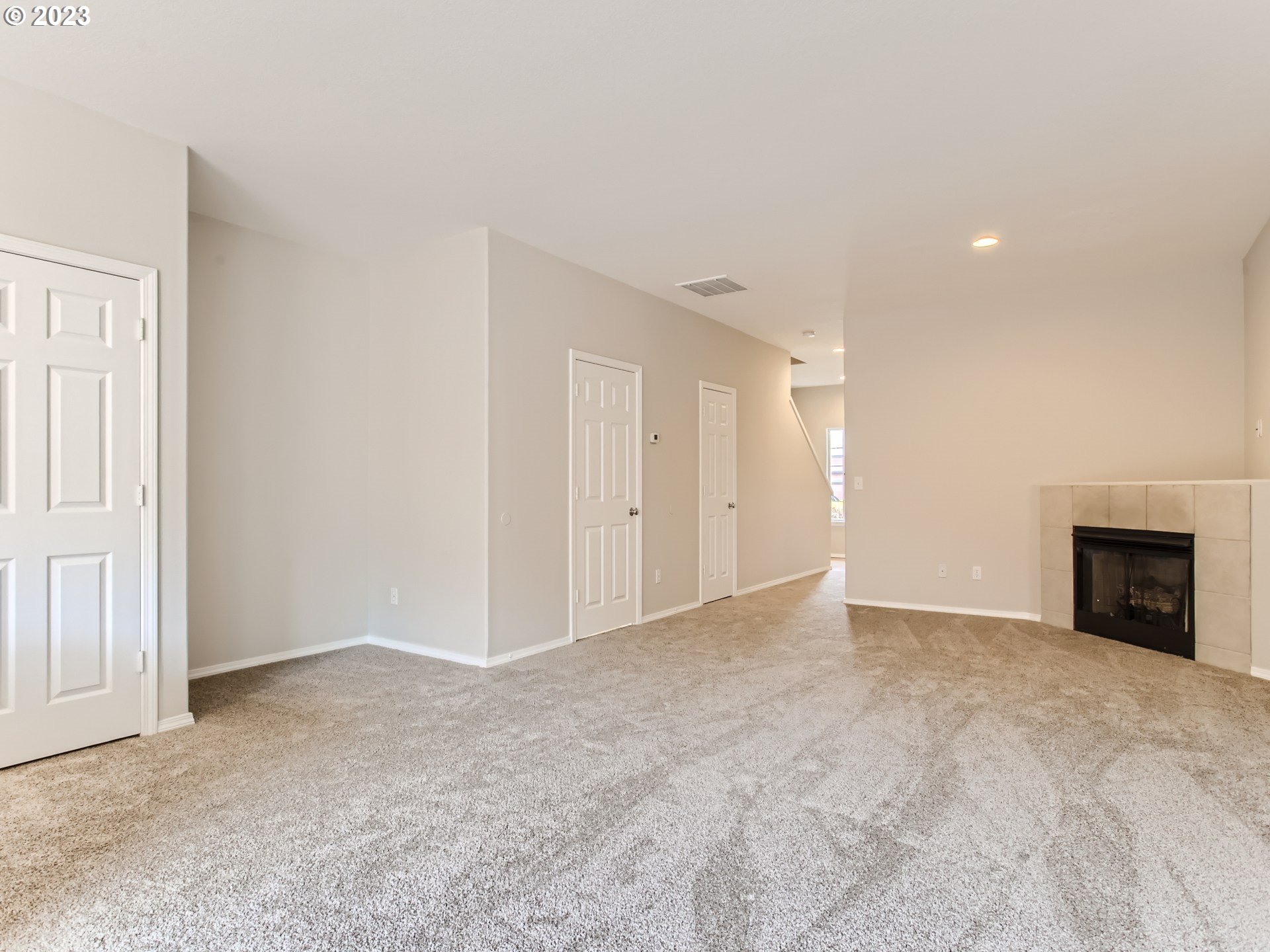 5877 Southeast 15th Drive Gresham, OR 97080 - Photo 7 of 27 a view of an empty room with a fireplace and a window