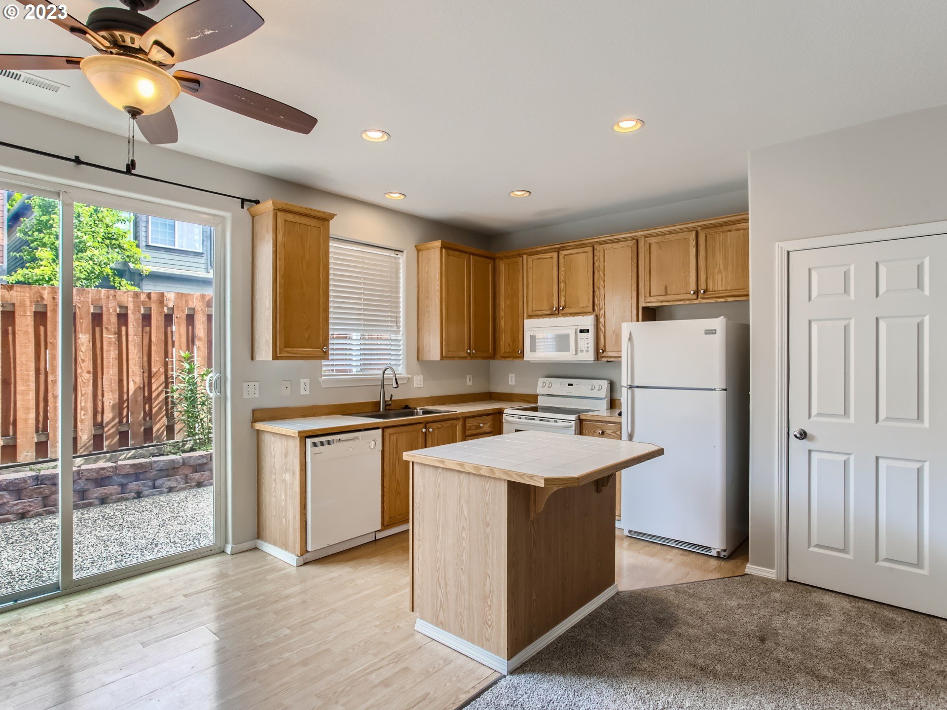 5877 Southeast 15th Drive Gresham, OR 97080 - Photo 9 of 27 a kitchen with refrigerator cabinets and large window