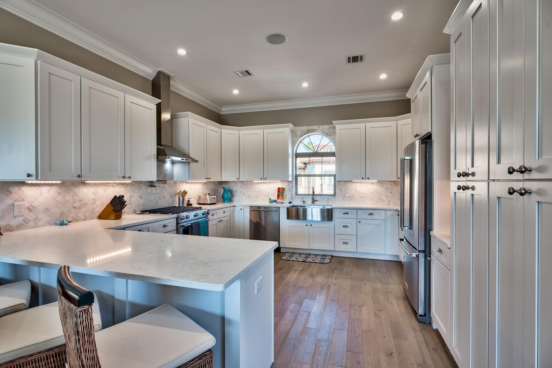 231 Rue St Tropez Miramar Beach, FL 32550 - Photo 13 of 35 a kitchen with refrigerator a sink dishwasher and wooden cabinets