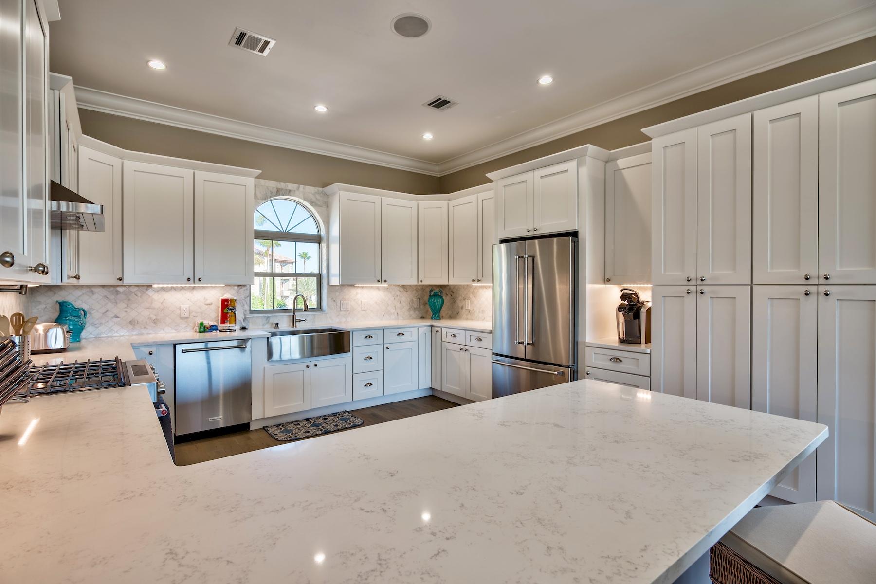 231 Rue St Tropez Miramar Beach, FL 32550 - Photo 14 of 35 a kitchen with stainless steel appliances granite countertop a refrigerator a sink dishwasher a stove and white cabinets with wooden floor