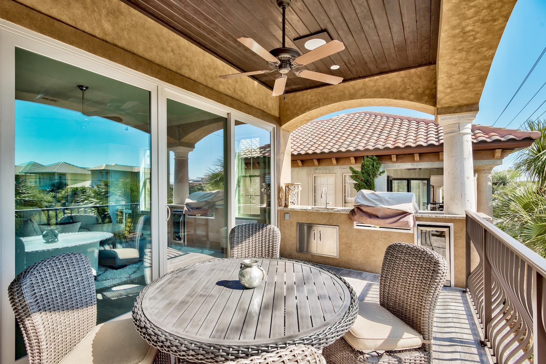 231 Rue St Tropez Miramar Beach, FL 32550 - Photo 21 of 35 a dining room with furniture a rug a flat screen tv and a large window
