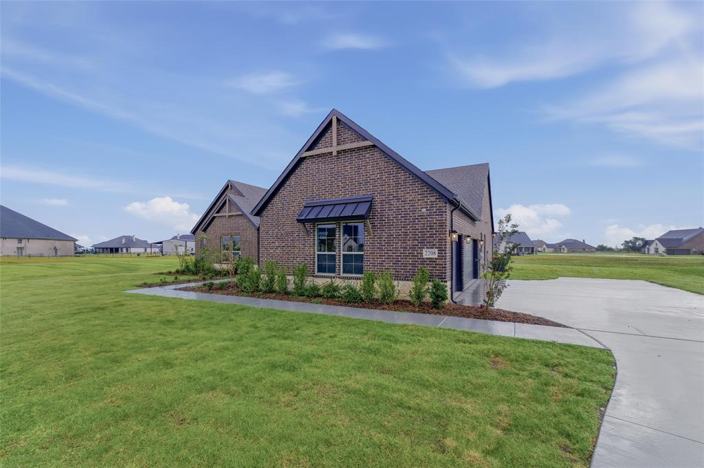 2208 Continent Court Krum, TX 76249 - Photo 2 of 26 Brick exterior with dark trim accents