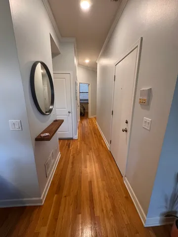 a view of a hallway with wooden floor