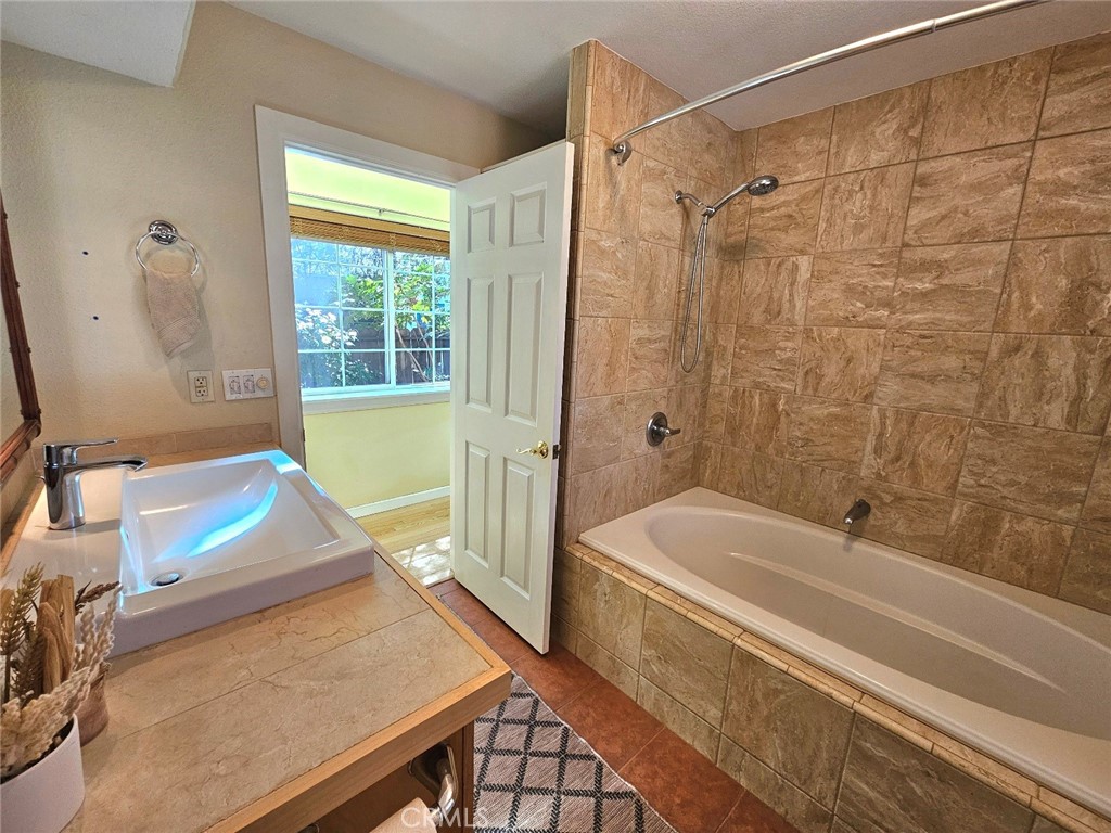 1631 Salem Street Chico, CA 95928 - Photo 29 of 71 a bathroom with a tub shower and sink