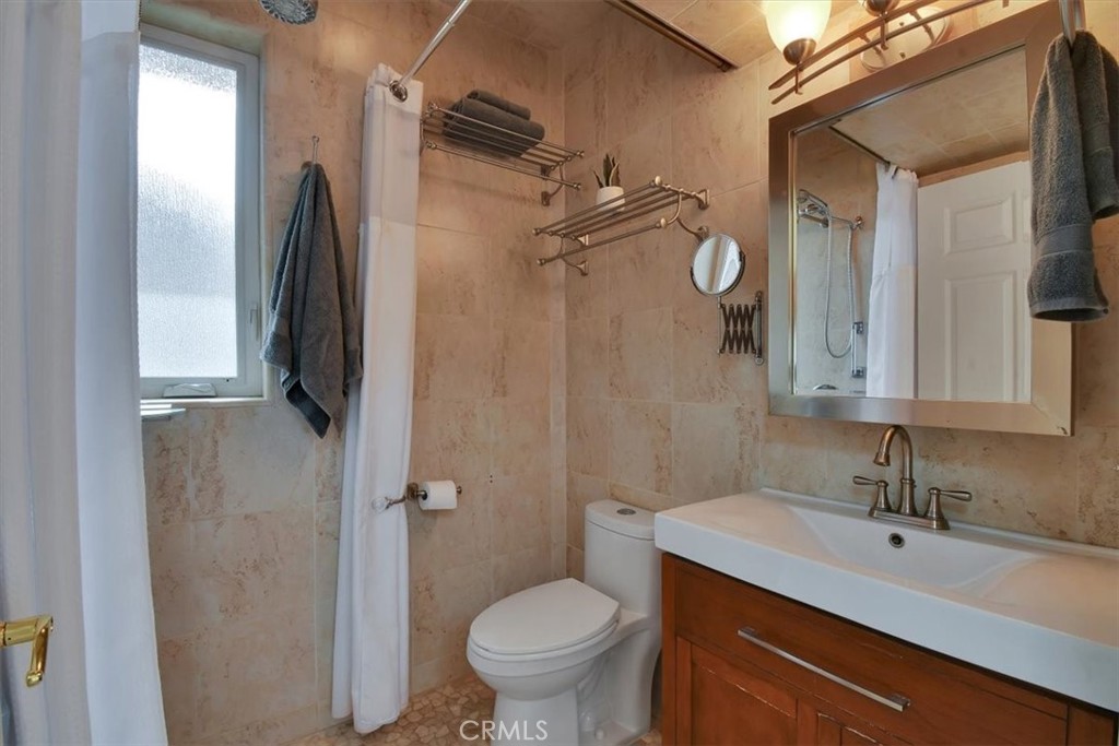 1631 Salem Street Chico, CA 95928 - Photo 43 of 71 a bathroom with a granite countertop sink toilet and shower