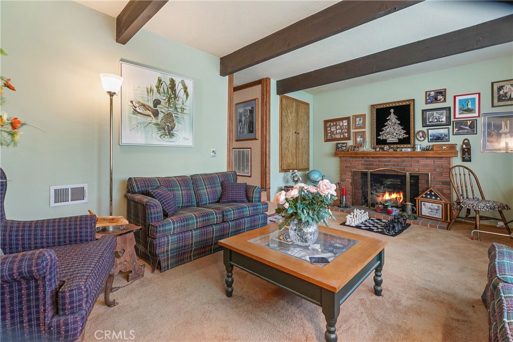 329 Grass Valley Road Lake Arrowhead, CA 92352 - Photo 10 of 31 a living room with furniture and a fireplace