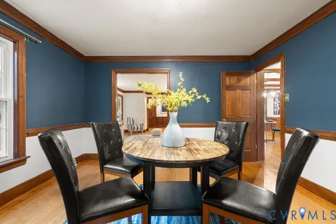 a dining room with furniture and window