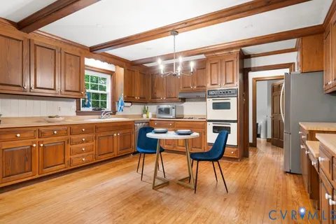 a kitchen with a sink cabinets and wooden floor