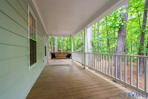 a view of a room with wooden floor and deck