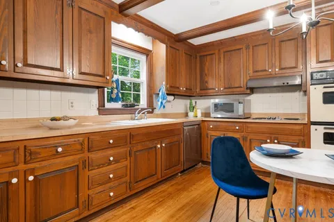 a kitchen with a sink a window and cabinets