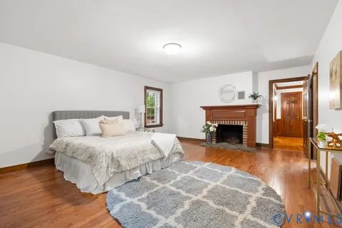 a spacious bedroom with a bed and a fireplace