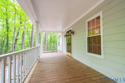 a view of porch with wooden floor and floor to ceiling window
