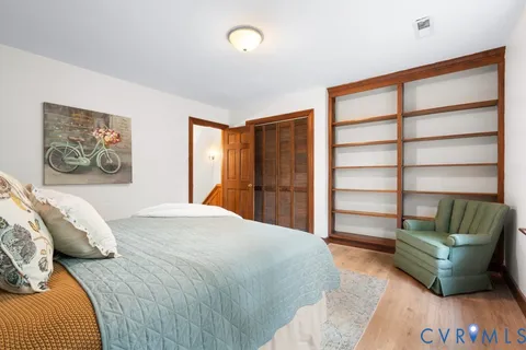 a spacious bedroom with a bed and a couch