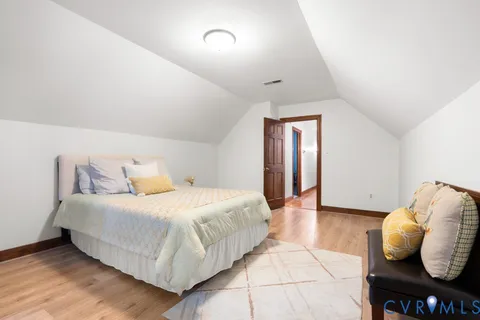 a bedroom with a bed and a large mirror
