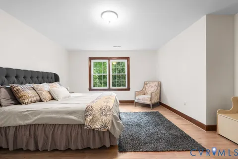a bedroom with a bed couch and a window