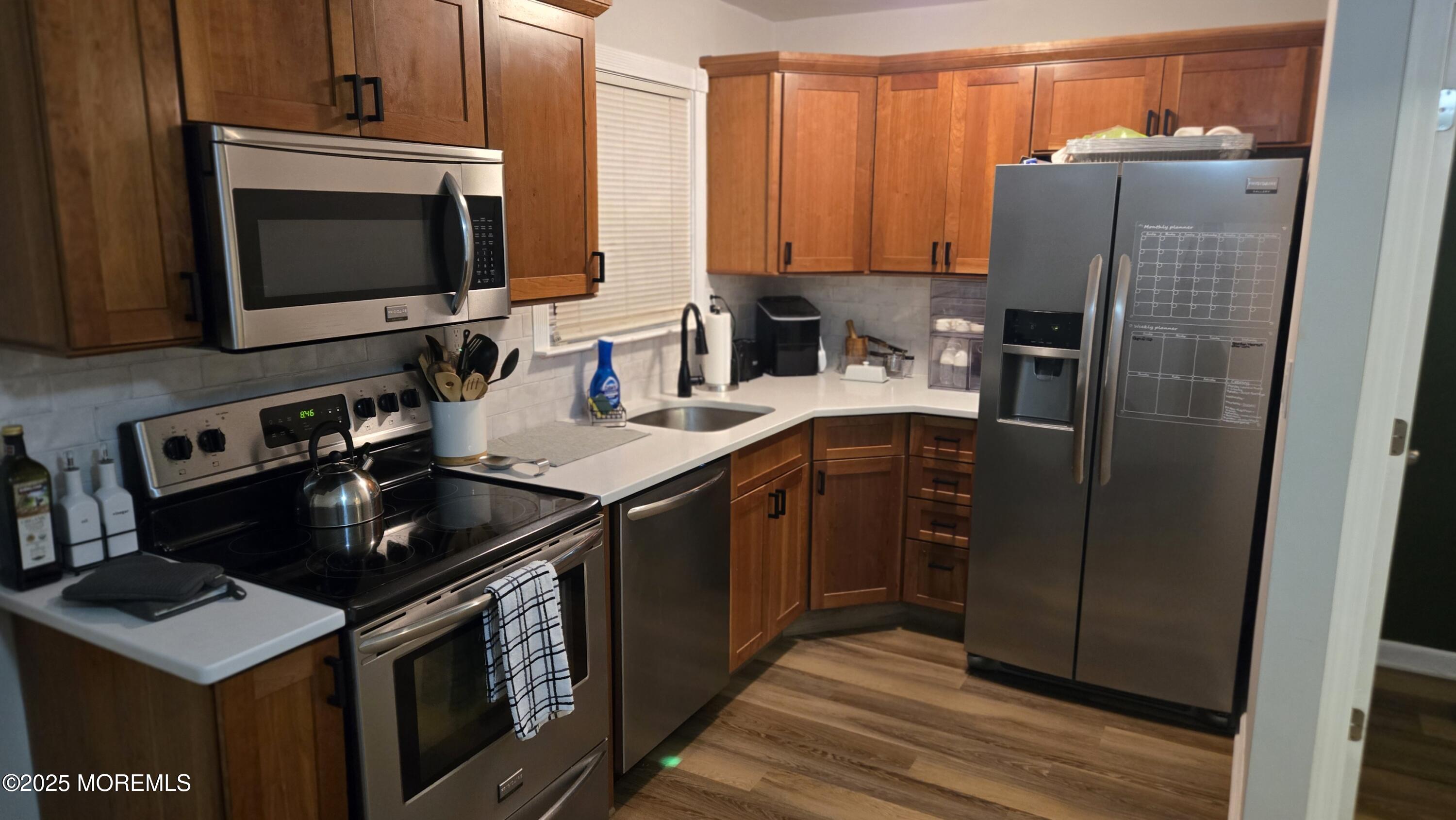 3 Primrose Lane Brick, NJ 08724 - Photo 2 of 8 a kitchen with stainless steel appliances granite countertop a stove a sink and a microwave